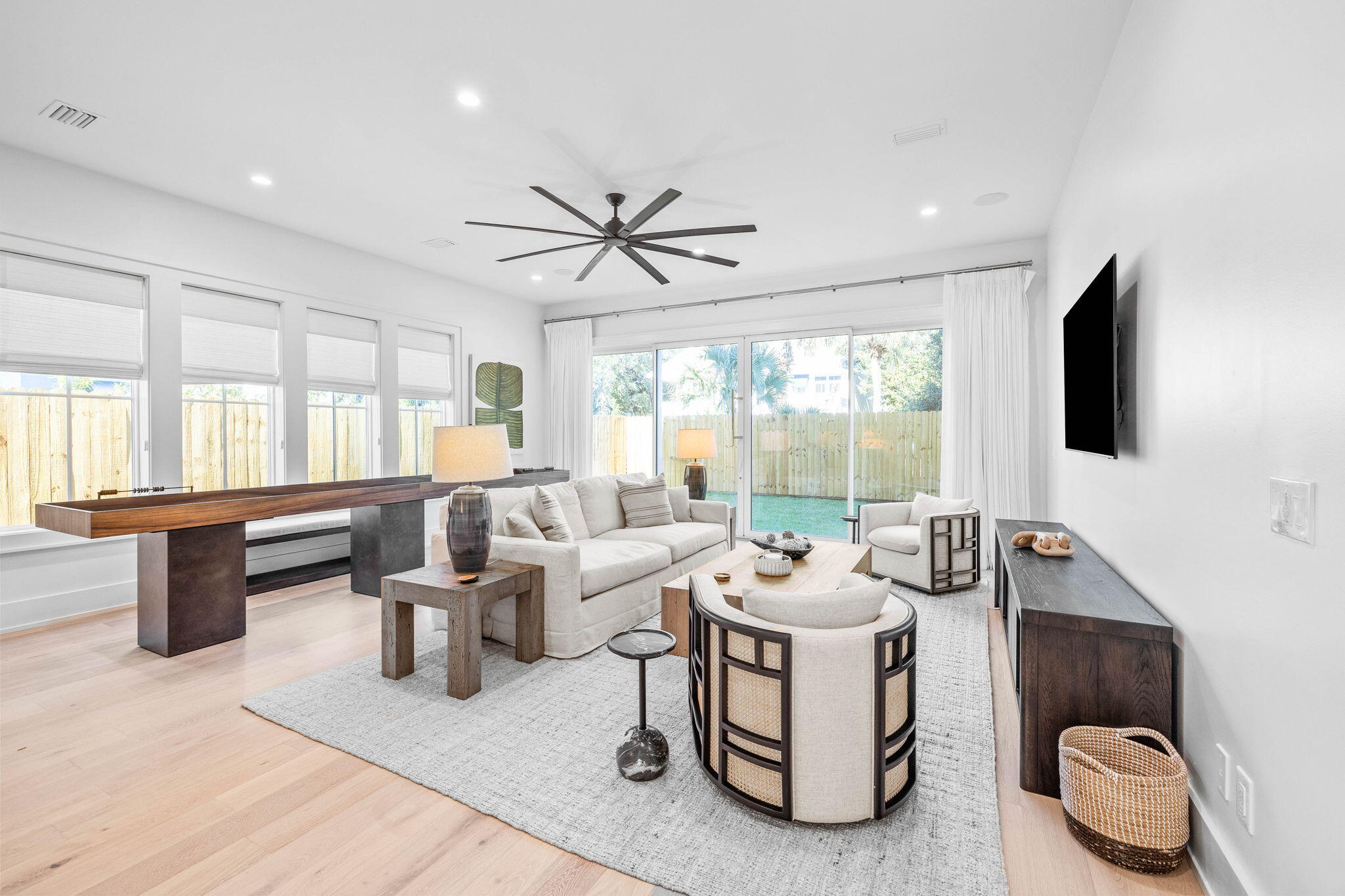 8069 East County Highway 30A Inlet Beach, FL 32461 - Photo 17 of 119 a living room with furniture a flat screen tv and a large window