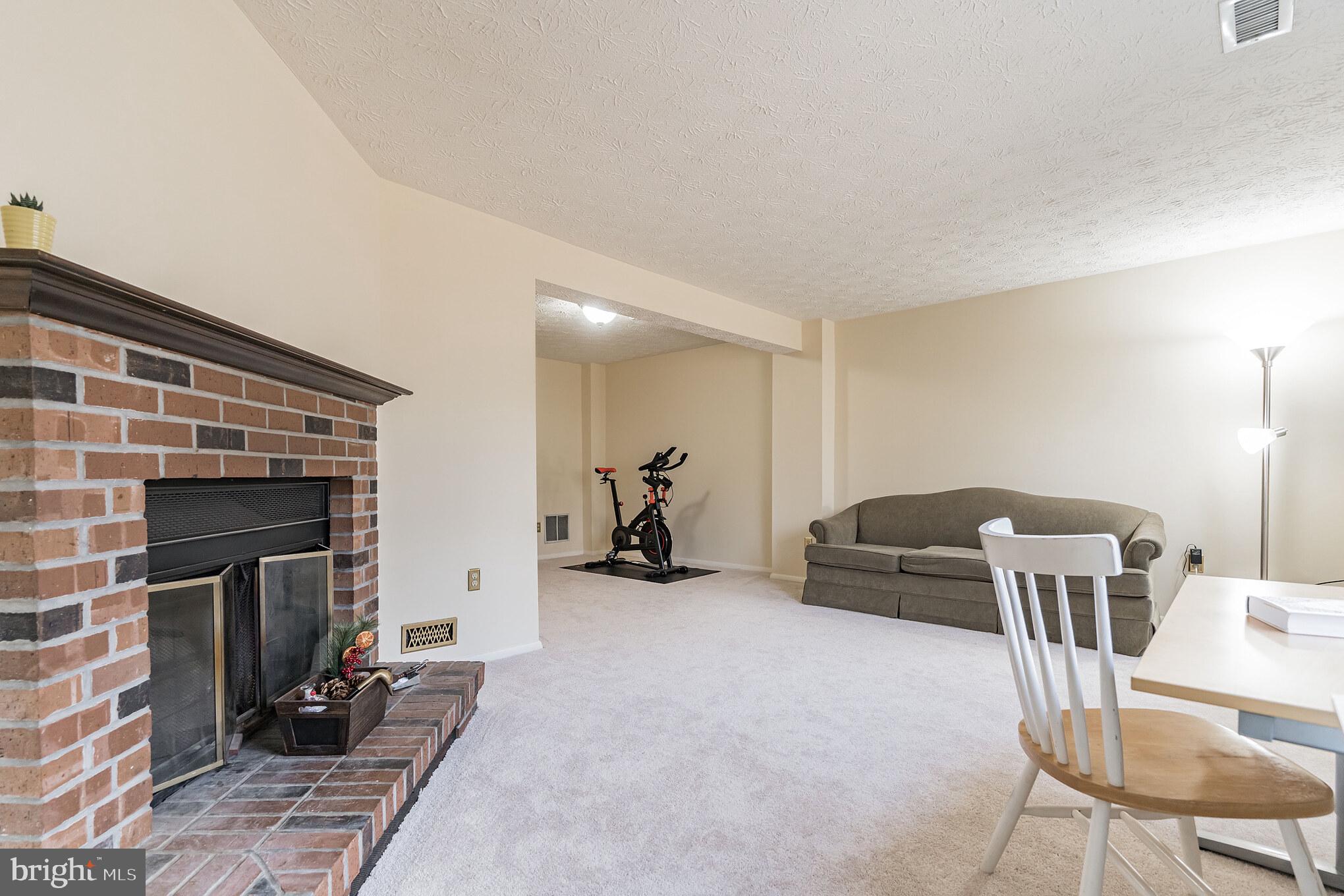 1610 Barnstead Drive Reston, VA 20194 - Photo 27 of 33 a living room with furniture and a fireplace