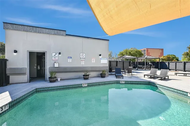 a view of a house with backyard and sitting area