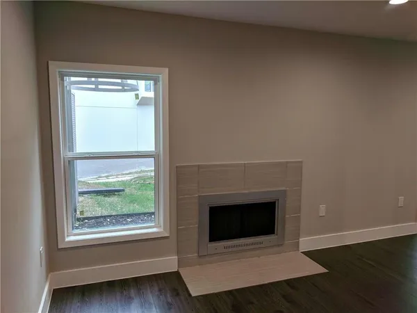 a room with a fireplace and a window