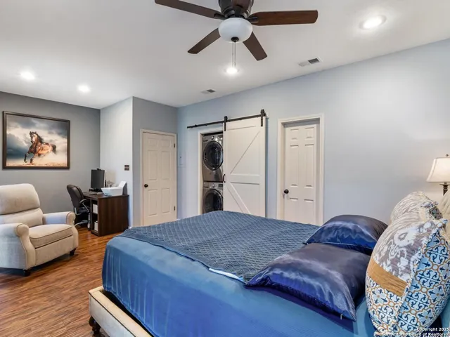 a spacious bedroom with a bed and furniture