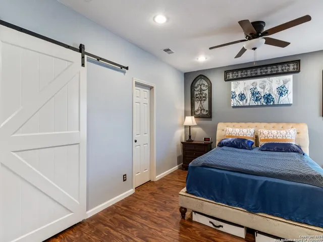 a bedroom with a bed and a painting on the wall