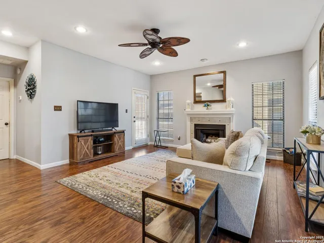 a living room with furniture a fireplace and a flat screen tv