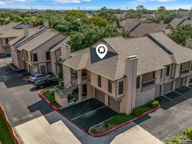 an aerial view of a house with a yard