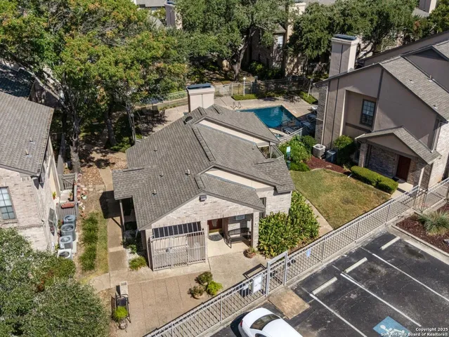 an aerial view of residential houses with outdoor space