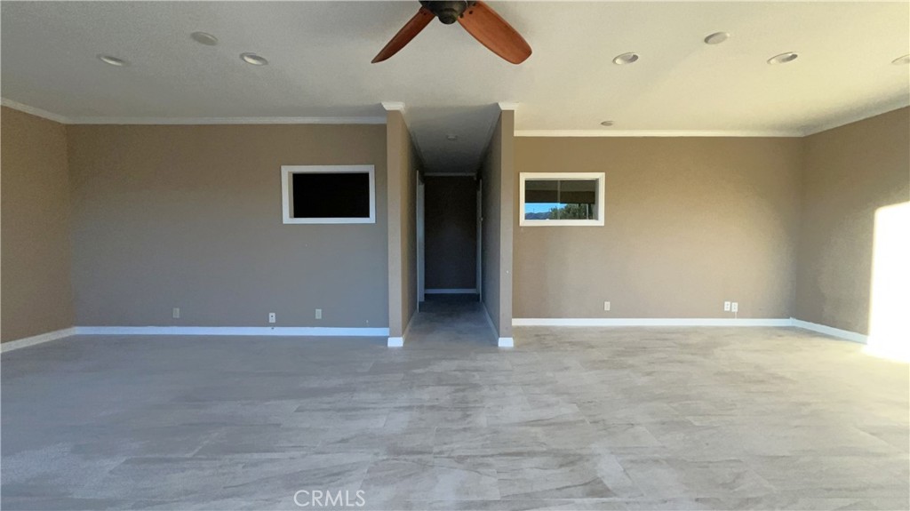 20786 Bear Valley Road, Unit D & E Apple Valley, CA 92308 - Photo 3 of 9 an empty room with ceiling fan and window