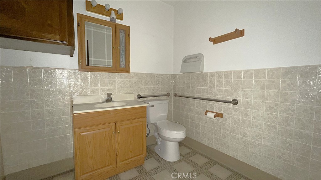 20786 Bear Valley Road, Unit D & E Apple Valley, CA 92308 - Photo 9 of 9 a bathroom with a sink a toilet and shower