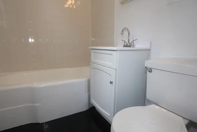 a bathroom with a sink a toilet and bathtub