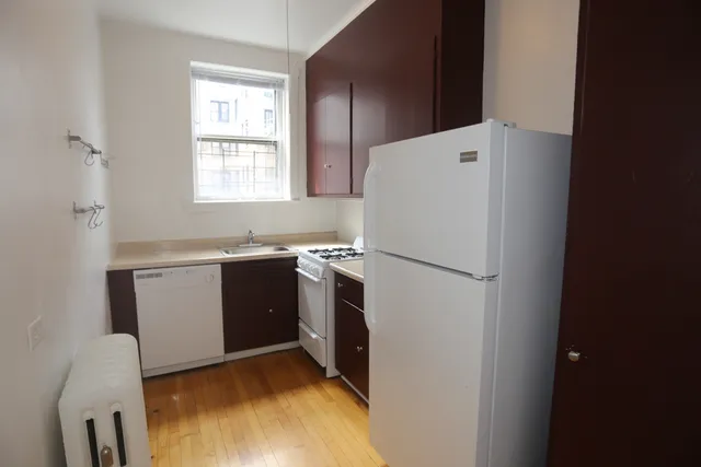 a utility room with cabinets washer and dryer