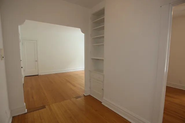 an empty room with wooden floor