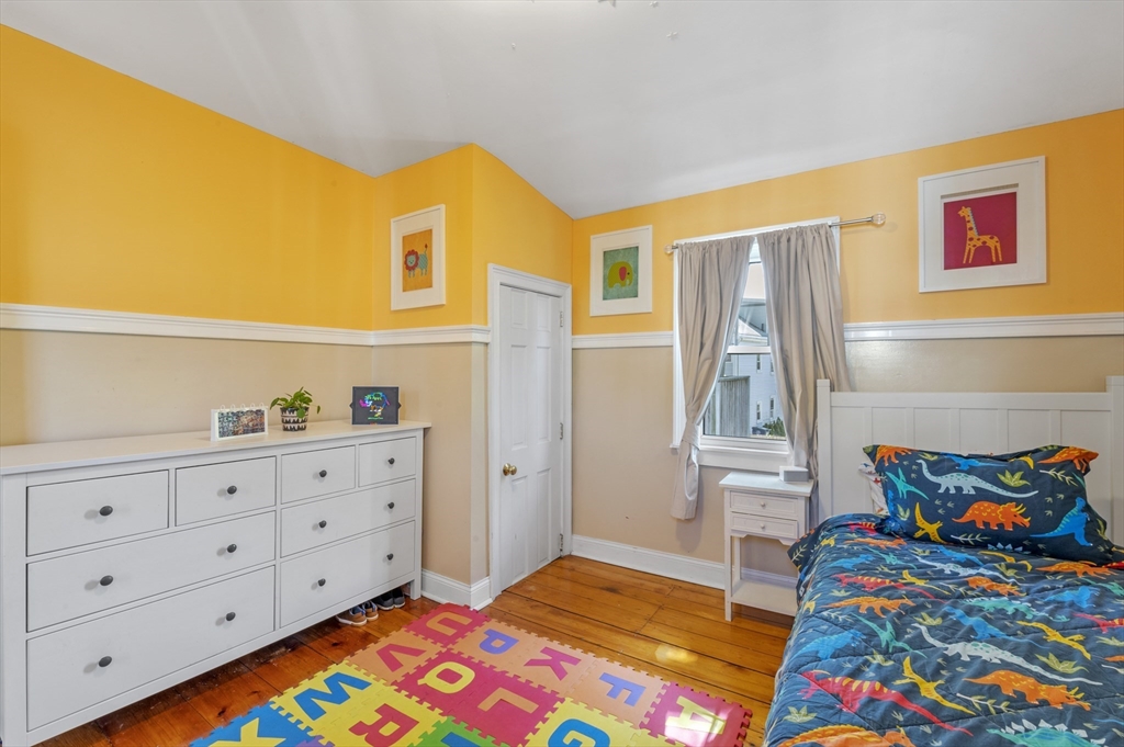 11 Williams Street, Unit 2 Salem, MA 01970 - Photo 15 of 33 a bedroom with a bed and wooden floor