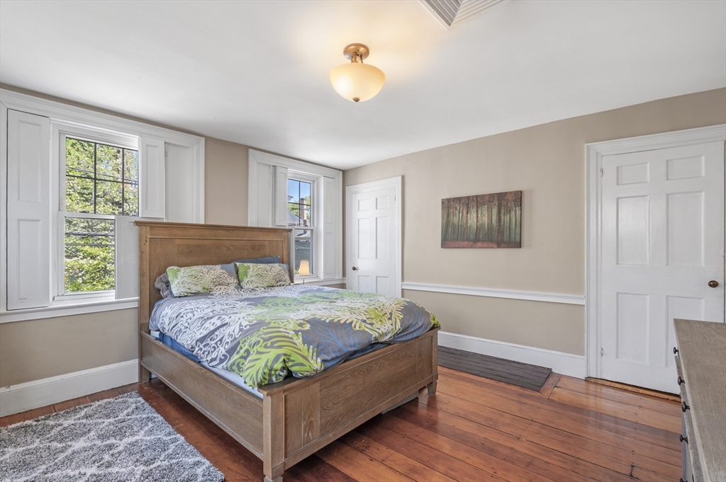 11 Williams Street, Unit 2 Salem, MA 01970 - Photo 18 of 33 a bedroom with a bed lamp and a window