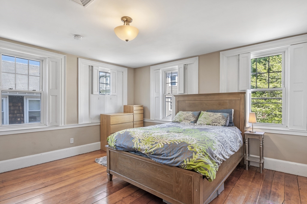 11 Williams Street, Unit 2 Salem, MA 01970 - Photo 19 of 33 a bedroom with a bed and wooden floor