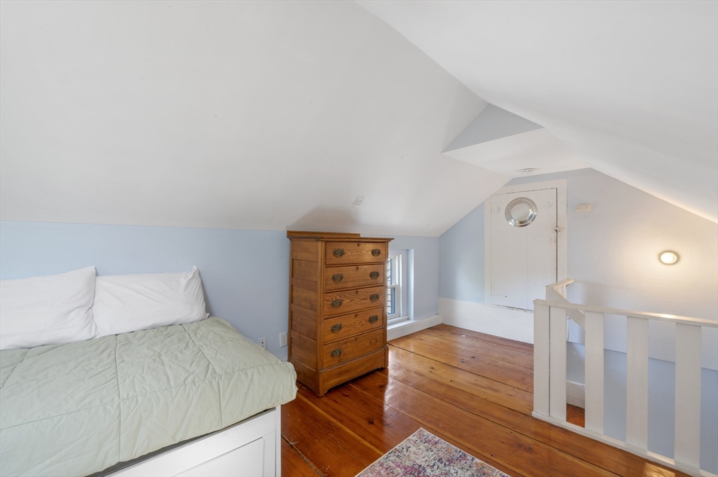 11 Williams Street, Unit 2 Salem, MA 01970 - Photo 23 of 33 a bedroom with a bed and wooden floor