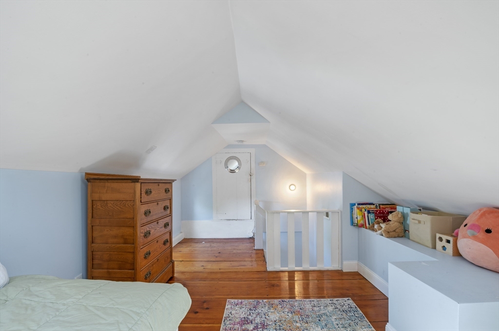 11 Williams Street, Unit 2 Salem, MA 01970 - Photo 24 of 33 a bedroom with a bed and wooden floor