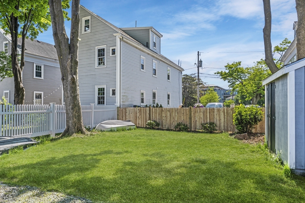 11 Williams Street, Unit 2 Salem, MA 01970 - Photo 27 of 33 a backyard of a house with lawn chairs and wooden fence