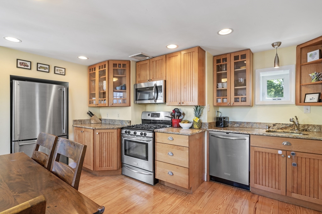 11 Williams Street, Unit 2 Salem, MA 01970 - Photo 8 of 33 a kitchen with stainless steel appliances granite countertop a stove top oven a sink dishwasher a refrigerator and cabinets with wooden floor