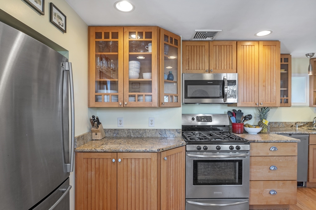 11 Williams Street, Unit 2 Salem, MA 01970 - Photo 10 of 33 a kitchen with stainless steel appliances granite countertop a stove a sink and a refrigerator