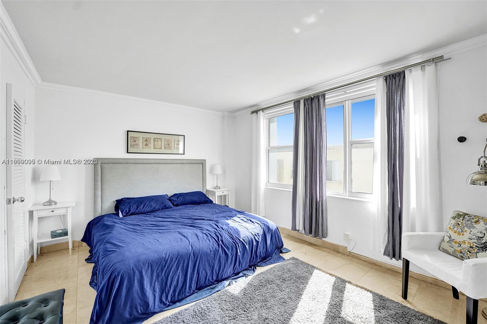 9195 Collins Avenue, Unit 304 Surfside, FL 33154 - Photo 14 of 32 a bedroom with a bed and a window