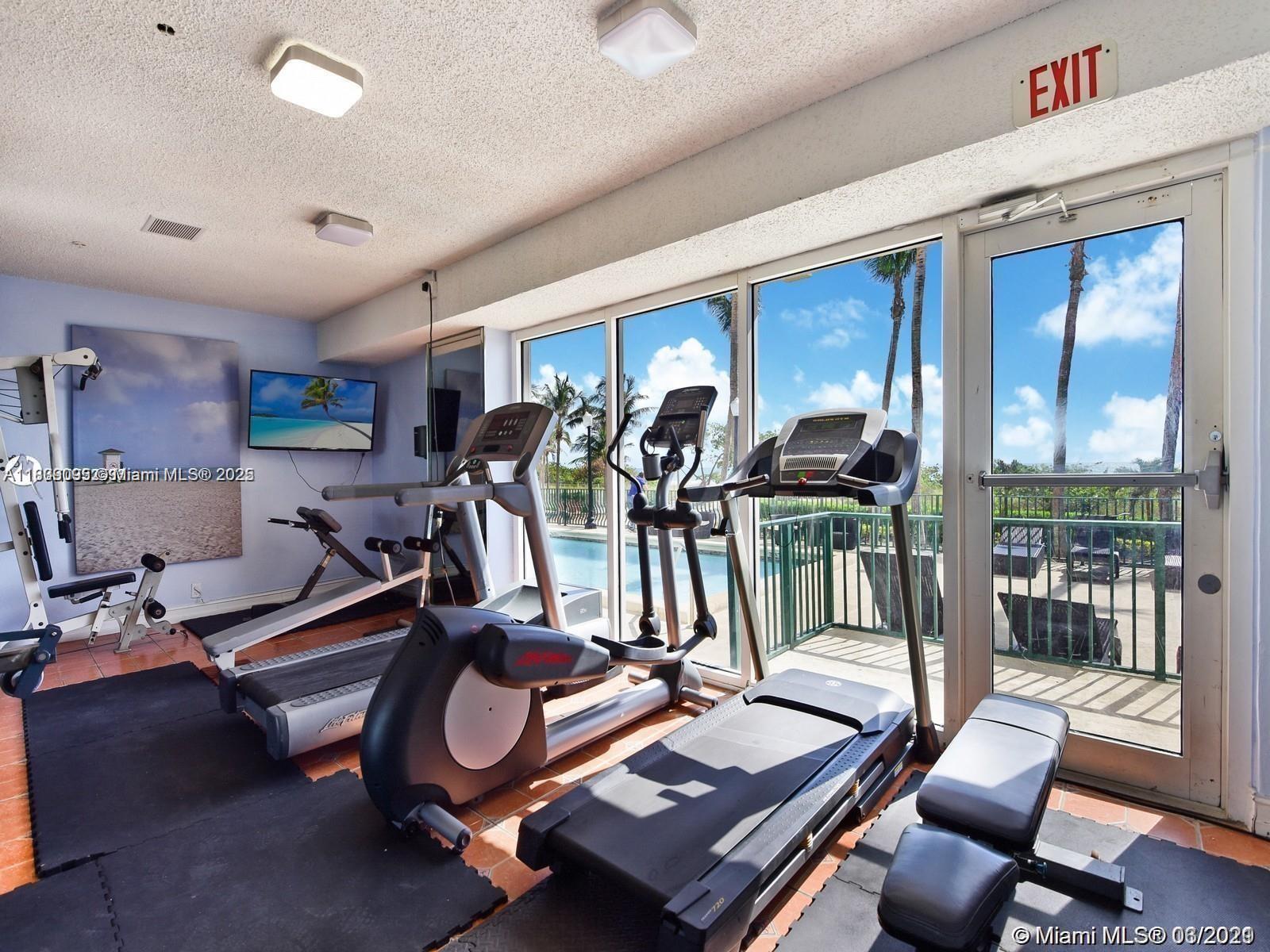 9195 Collins Avenue, Unit 304 Surfside, FL 33154 - Photo 25 of 32 a view of a room with gym equipment