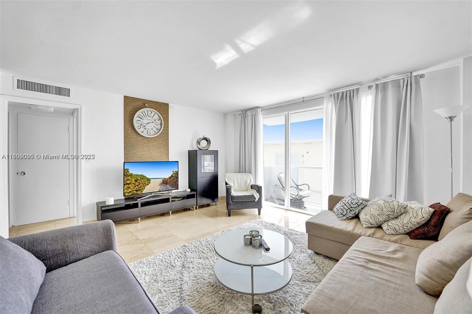 9195 Collins Avenue, Unit 304 Surfside, FL 33154 - Photo 3 of 32 a living room with furniture a rug and a window