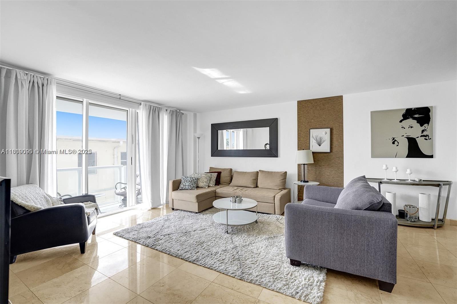 9195 Collins Avenue, Unit 304 Surfside, FL 33154 - Photo 4 of 32 a living room with furniture and a large window