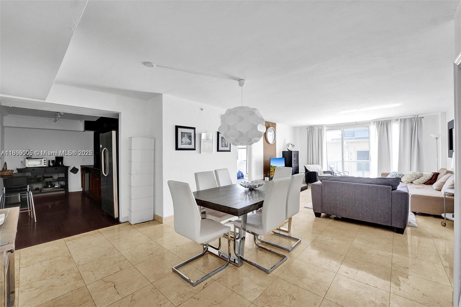 9195 Collins Avenue, Unit 304 Surfside, FL 33154 - Photo 5 of 32 a living room with furniture and a large window