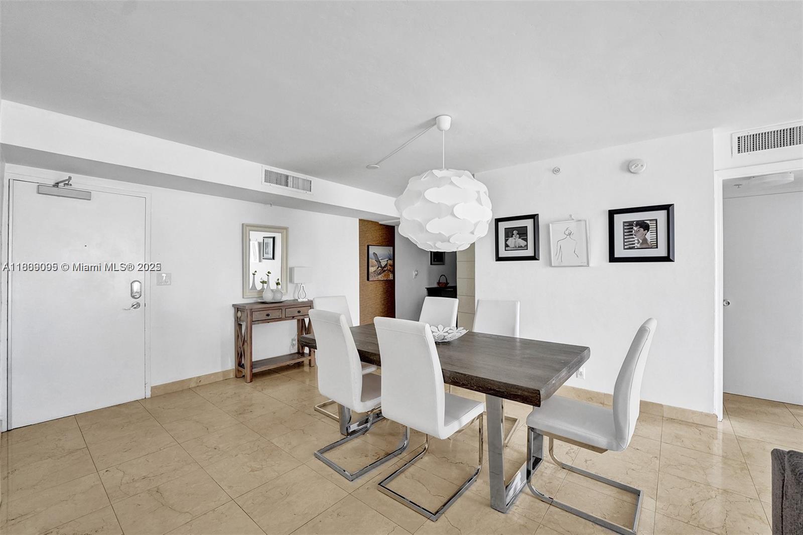 9195 Collins Avenue, Unit 304 Surfside, FL 33154 - Photo 6 of 32 a view of a dining room with furniture