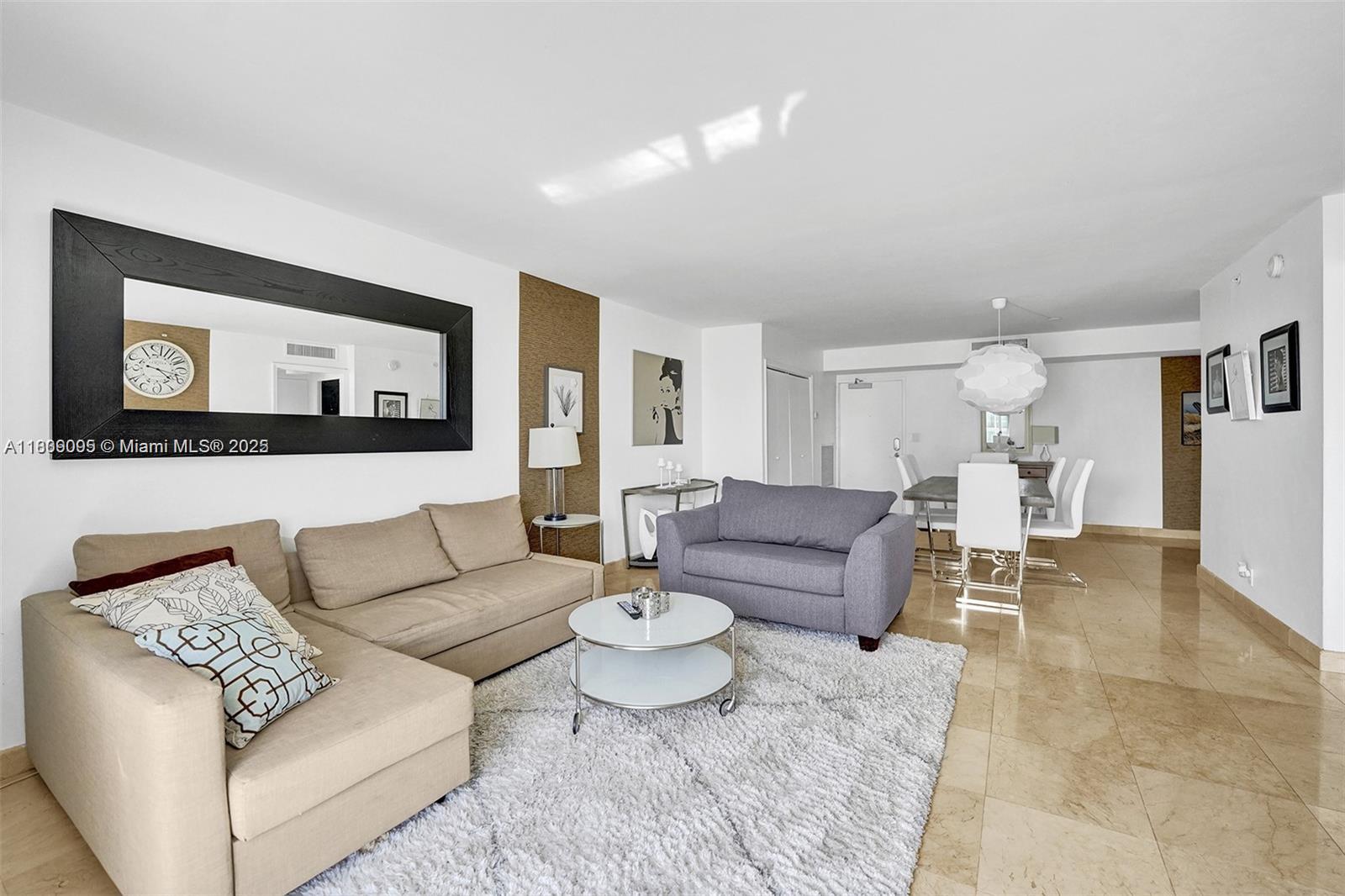 9195 Collins Avenue, Unit 304 Surfside, FL 33154 - Photo 9 of 32 a living room with furniture and wooden floor