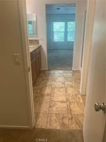 a white toilet sitting next to a white cabinet