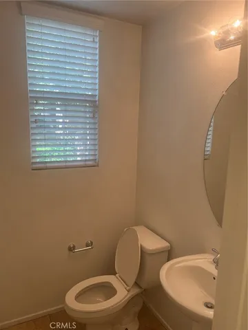 a view of an empty room with a fireplace and a cabinet