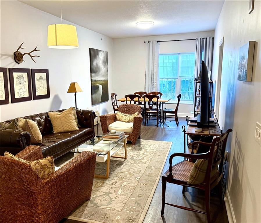 195 14th Street Northeast, Unit 312 Atlanta, GA 30309 - Photo 11 of 33 a living room with furniture and a flat screen tv