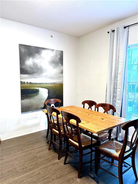 195 14th Street Northeast, Unit 312 Atlanta, GA 30309 - Photo 13 of 33 a view of a dining room with furniture and wooden floor