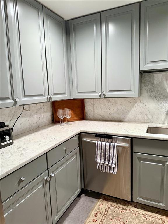 195 14th Street Northeast, Unit 312 Atlanta, GA 30309 - Photo 16 of 33 a kitchen with granite countertop cabinets stainless steel appliances a sink and a counter top
