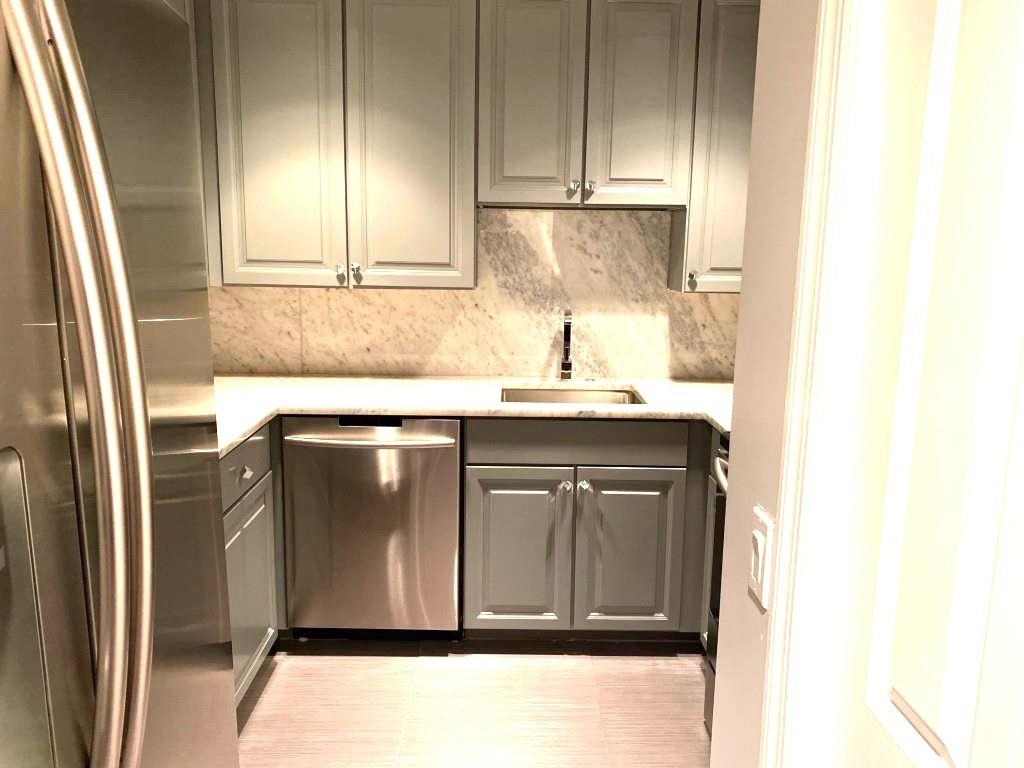 195 14th Street Northeast, Unit 312 Atlanta, GA 30309 - Photo 20 of 33 a kitchen with stainless steel appliances granite countertop a refrigerator and a sink