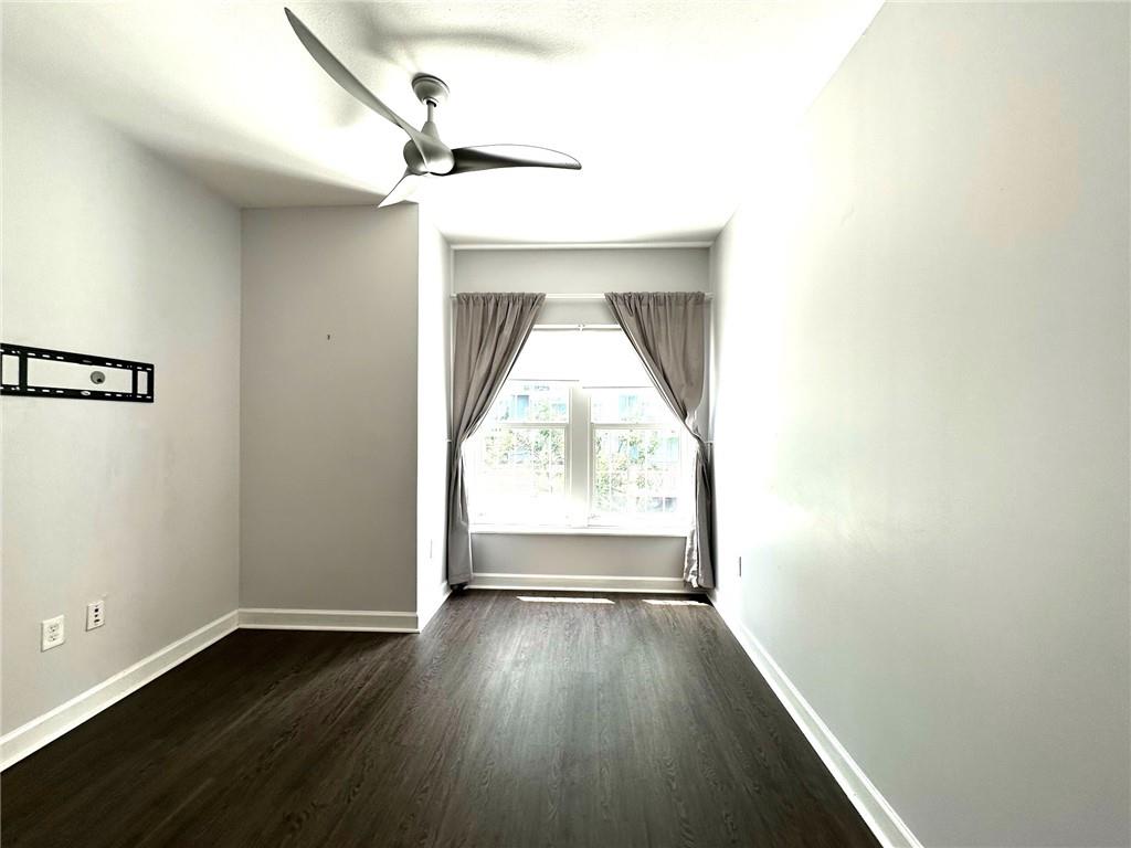 195 14th Street Northeast, Unit 312 Atlanta, GA 30309 - Photo 27 of 33 an empty room with wooden floor cabinet and windows