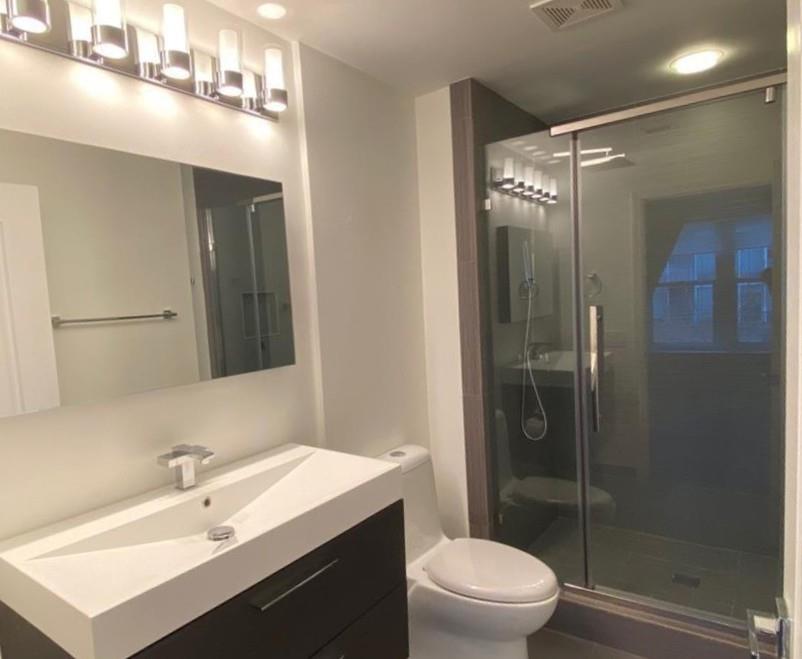 195 14th Street Northeast, Unit 312 Atlanta, GA 30309 - Photo 29 of 33 a bathroom with a sink a toilet and shower