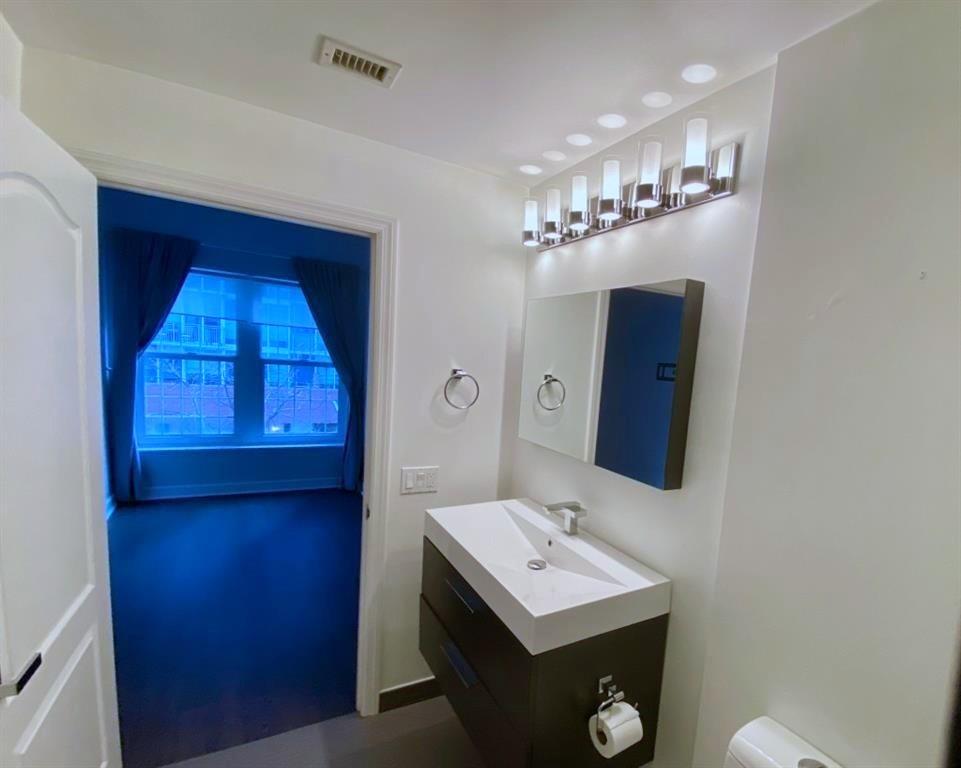 195 14th Street Northeast, Unit 312 Atlanta, GA 30309 - Photo 30 of 33 a bathroom with a sink and a mirror