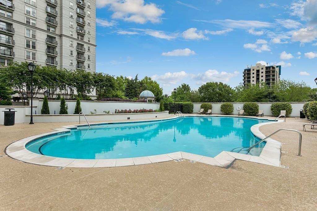 195 14th Street Northeast, Unit 312 Atlanta, GA 30309 - Photo 10 of 33 a view of a swimming pool and a yard