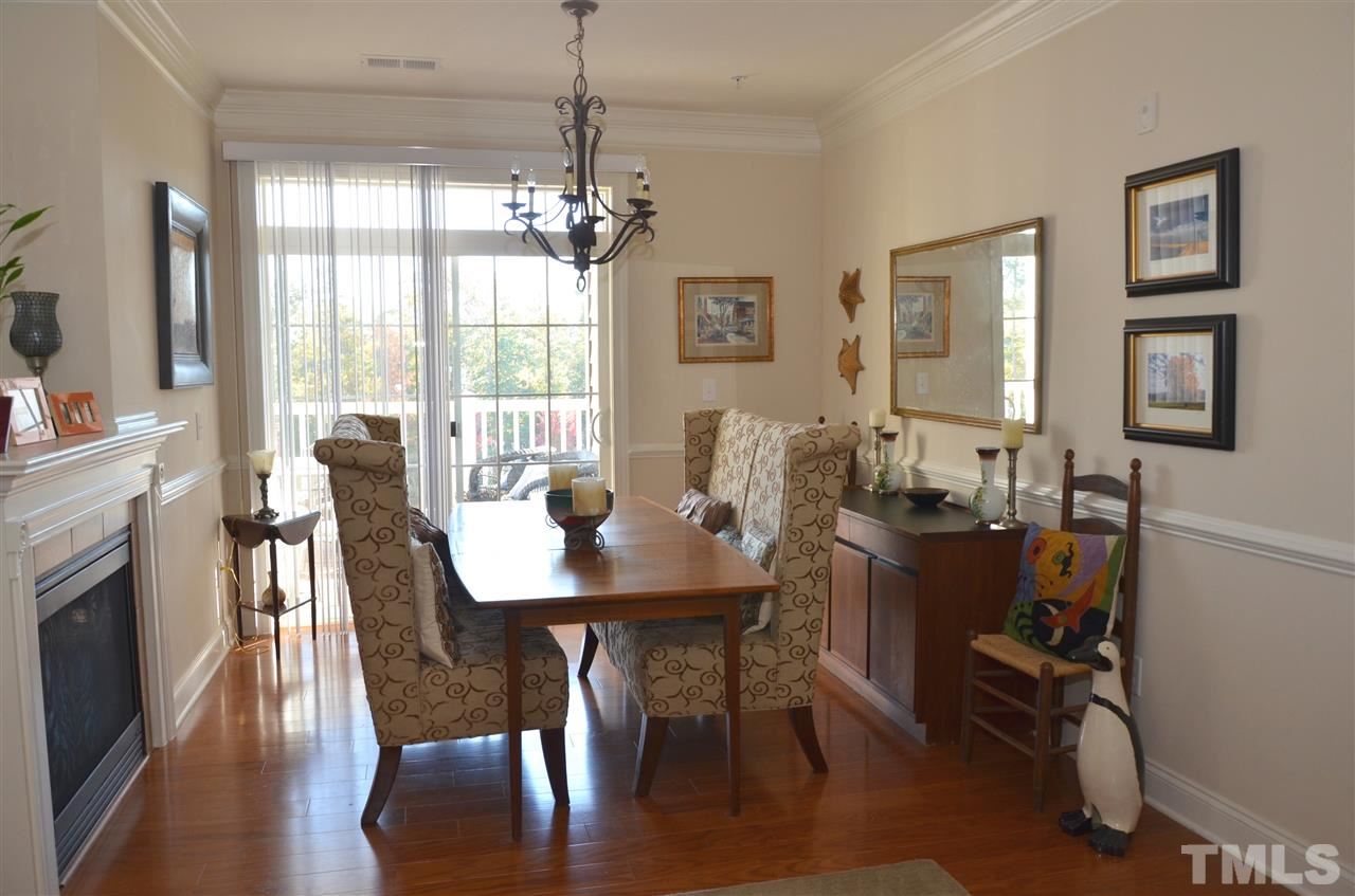 10421 Rosegate Court, Unit 203 Raleigh, NC 27617 - Photo 5 of 8 a view of a dining room with furniture window and wooden floor