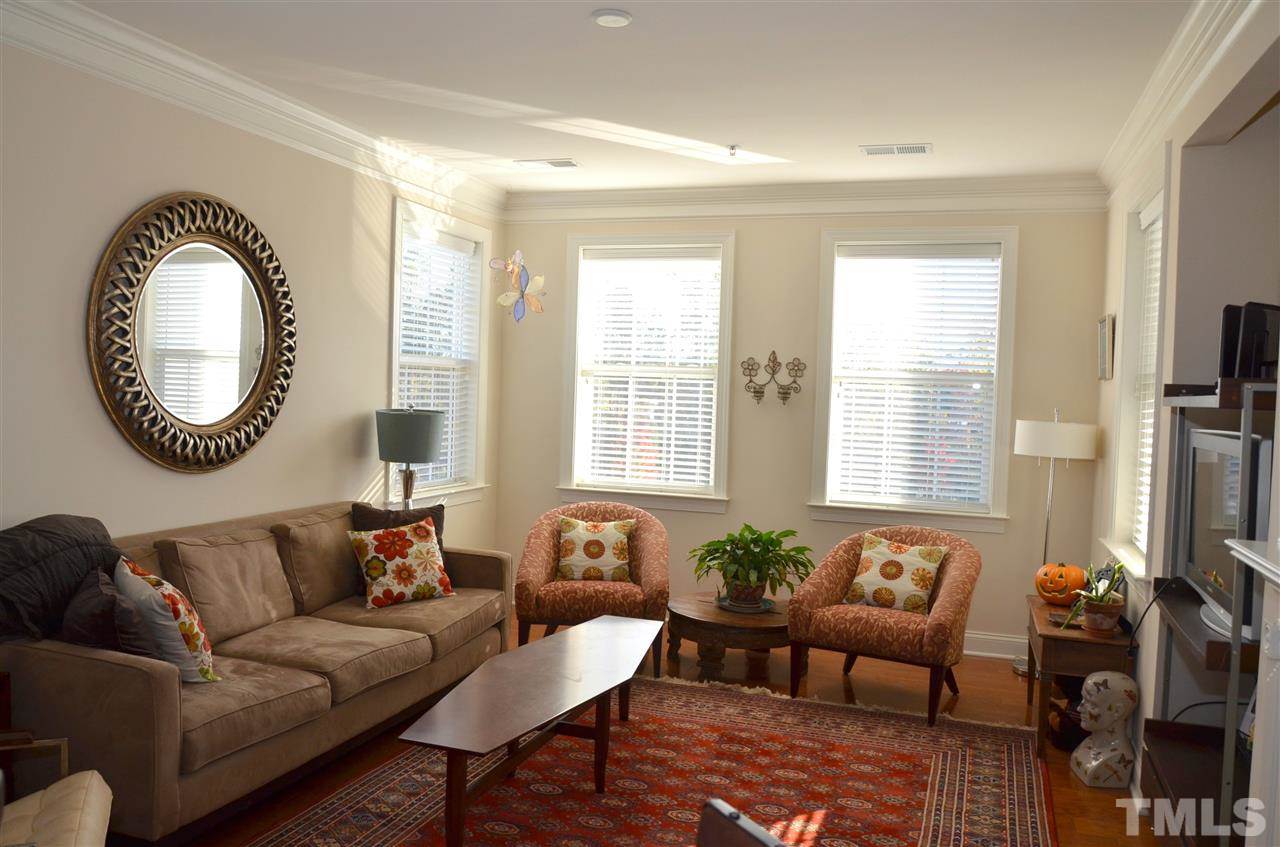 10421 Rosegate Court, Unit 203 Raleigh, NC 27617 - Photo 7 of 8 a living room with furniture and a large window
