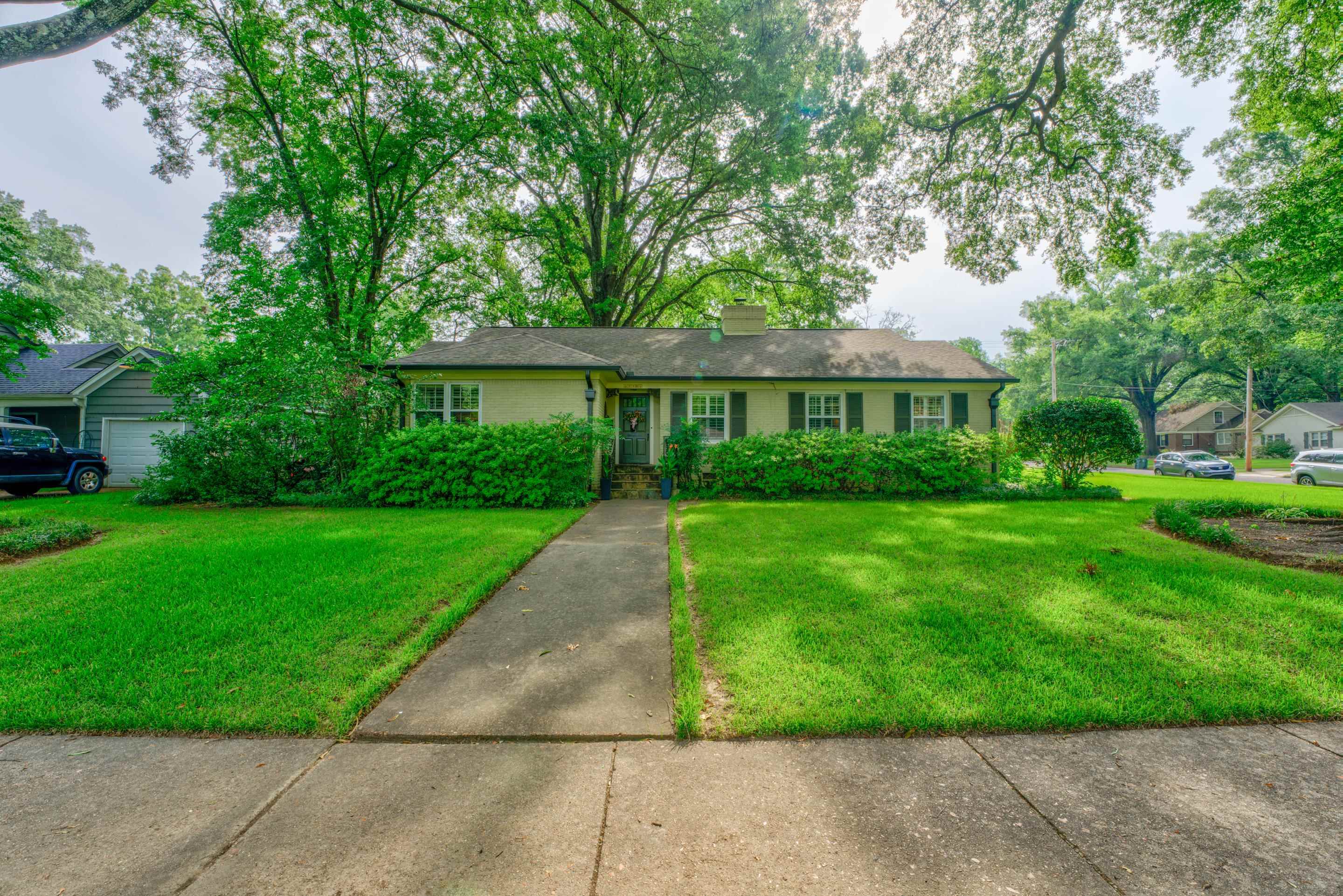 a view of house that has a yard