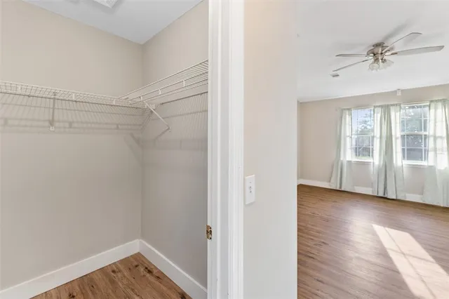 an aerial view of residential houses with outdoor space and trees