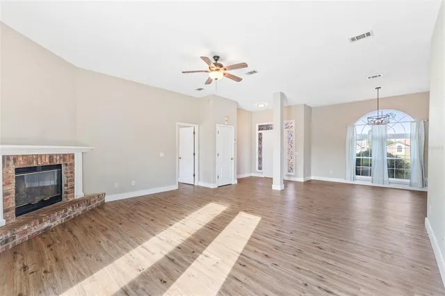 a view of a room with wooden floor portable swimming pool and windows