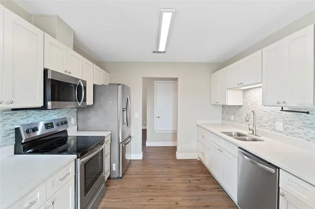 a kitchen with a sink cabinets and window