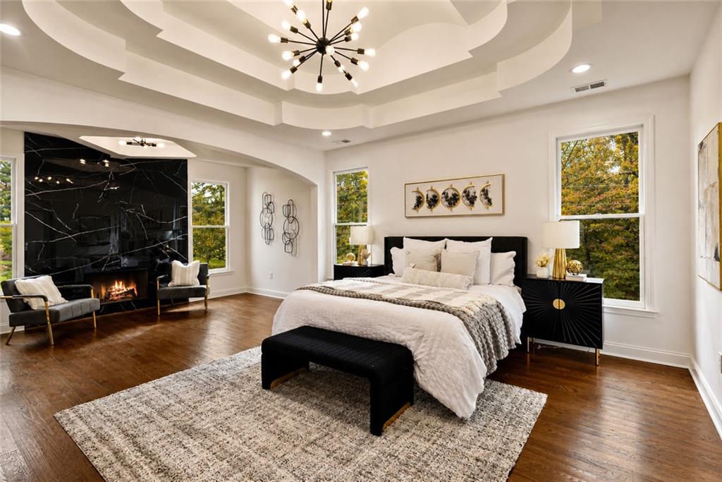 1217 Cabin Bridge Road Bethlehem, GA 30620 - Photo 22 of 43 a spacious bedroom with a bed a couch and a window
