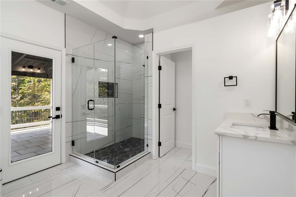 1217 Cabin Bridge Road Bethlehem, GA 30620 - Photo 27 of 43 a bathroom with a shower and a sink