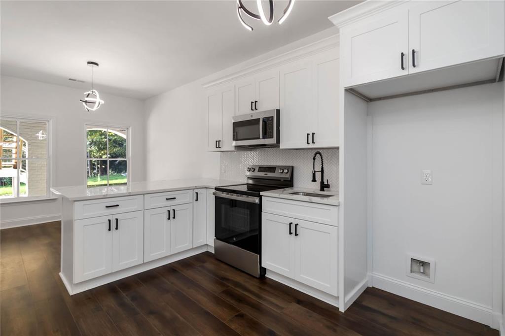 1217 Cabin Bridge Road Bethlehem, GA 30620 - Photo 32 of 43 a kitchen with granite countertop white cabinets and black stainless steel appliances