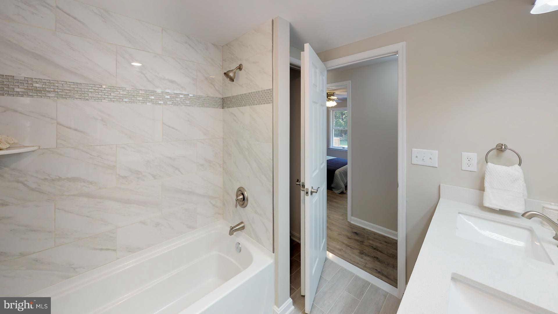 13284 Joy Road Lusby, MD 20657 - Photo 14 of 29 a bathroom with a bathtub and a shower