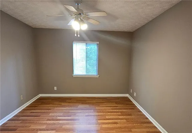 a view of a room with wooden floor and window